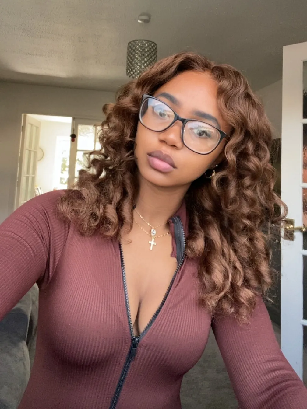 Chloe, Deep Tissue Therapist, maroon zip-top glasses portrait at All Queens Wellness Spa, Kindaruma Road, Kilimani, Nairobi.