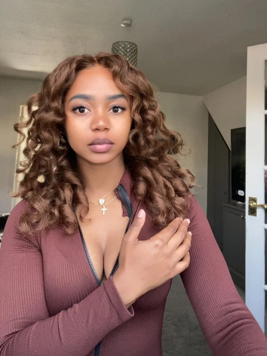 Chloe, Deep Tissue Therapist, maroon zip-top high-angle portrait at All Queens Wellness Spa, Kindaruma Road, Kilimani, Nairobi.